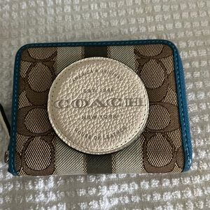 Fabric and leather Zippered Coach wallet. Like new. No marks of any kind.